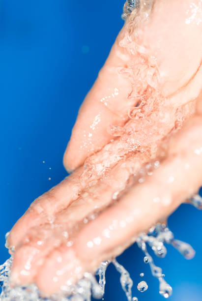 istock hand in the water on a blue background 858267496