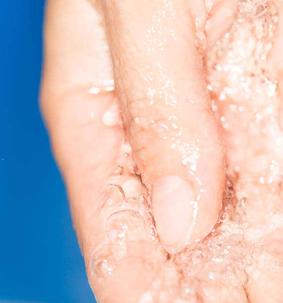 istock hand in the water on a blue background 858267580