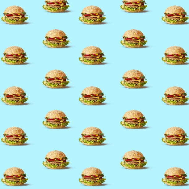 istock Many tasty fly hamburgers on blue texture. 858268320
