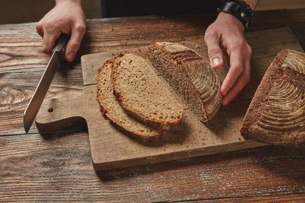 istock Man slicing tasty fresh bread. 858268492