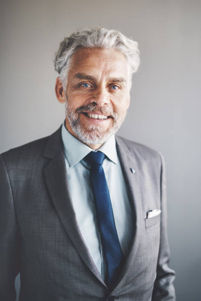 istock Mature corporate executive wearing a suit and smiling confidently 858268956
