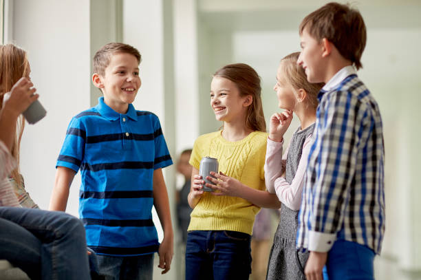 istock group of school kids with soda cans in corridor 858276100