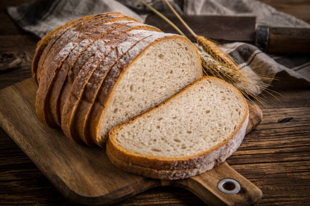 istock Sliced loaf of bread on a chopping board. 858276312