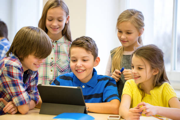 istock group of school kids with tablet pc in classroom 858276400