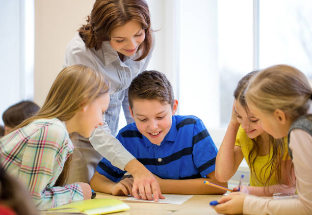 istock group of school kids writing test in classroom 858276460