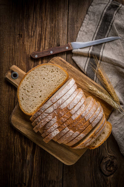 istock Sliced loaf of bread on a chopping board. 858276636