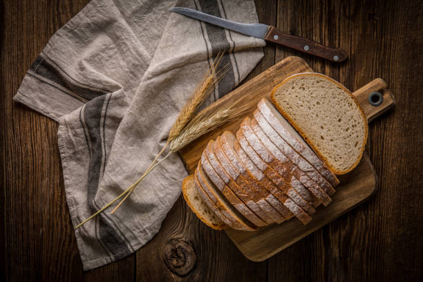 istock Sliced loaf of bread on a chopping board. 858276832