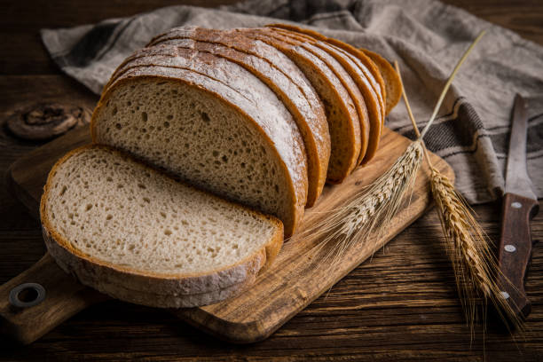 istock Sliced loaf of bread on a chopping board. 858277010