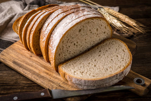 istock Sliced loaf of bread on a chopping board. 858277442