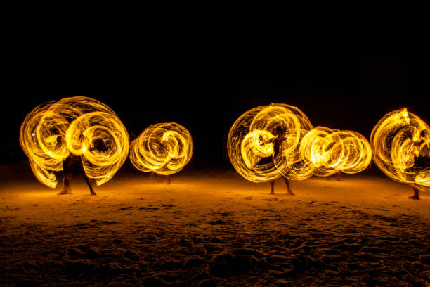 istock Spin the fire Night show, Spin Fire show on the beach Thailand 858285784