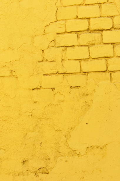 Texture of old yellow brick wall surface with cement and concrete seams