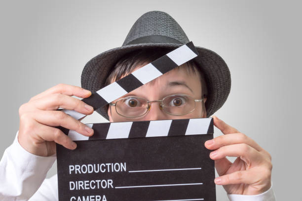 istock Actress with movie clapper behind face. 858292646