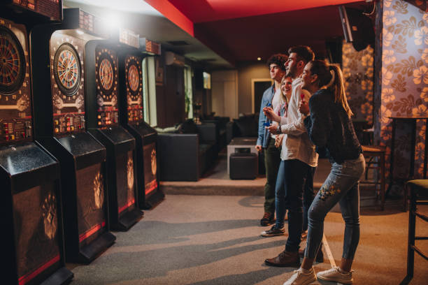 istock Young happy people having fun while playing darts in a pub. 858296012