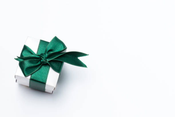 Close-up of a green gift box with ribbon and bow.