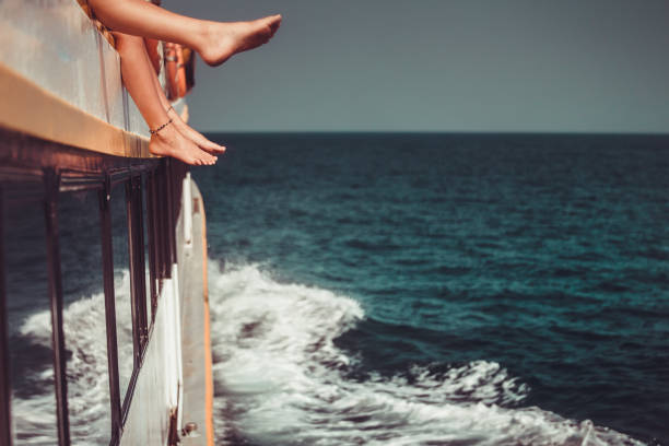 istock Young people chilling in boat. Only legs close up 858302818