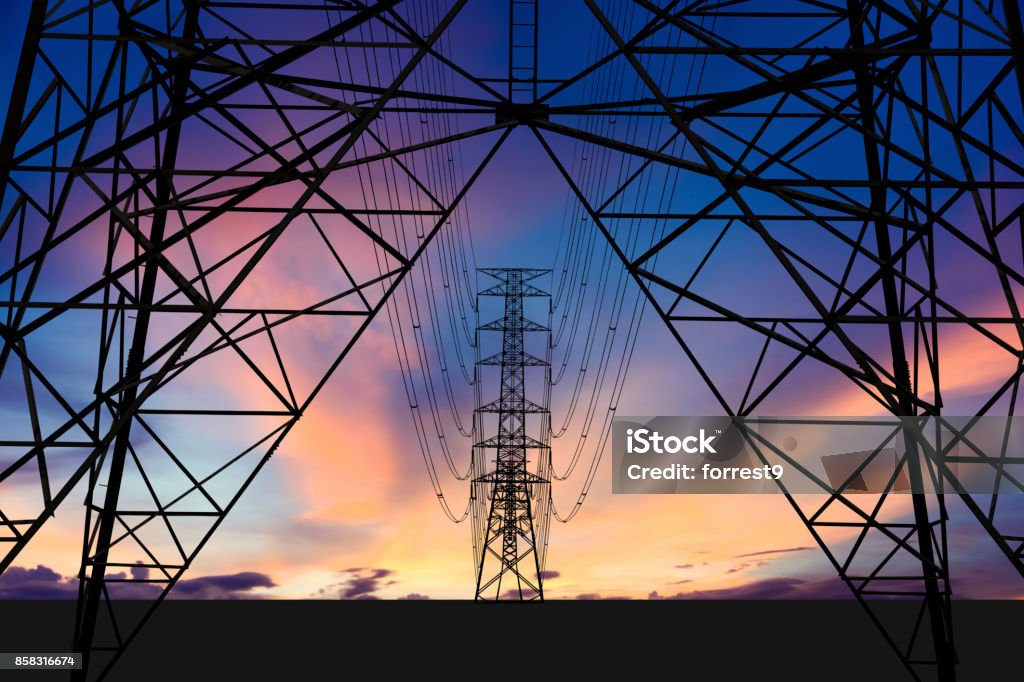 High voltage tower and Colorful sky. Silhouette image. High voltage tower and Colorful sky. This has clipping path for structure. Fuel and Power Generation Stock Photo
