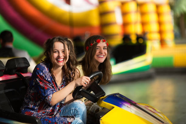 istock Happy girlfriends driving a bumper car 858322578