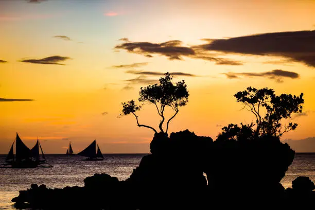 famous willys rock silhouette, boracay island, the philippines.
