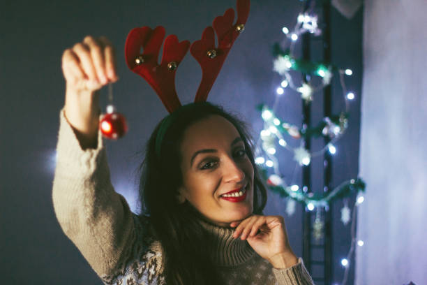 istock woman holding new year ornament 858327048