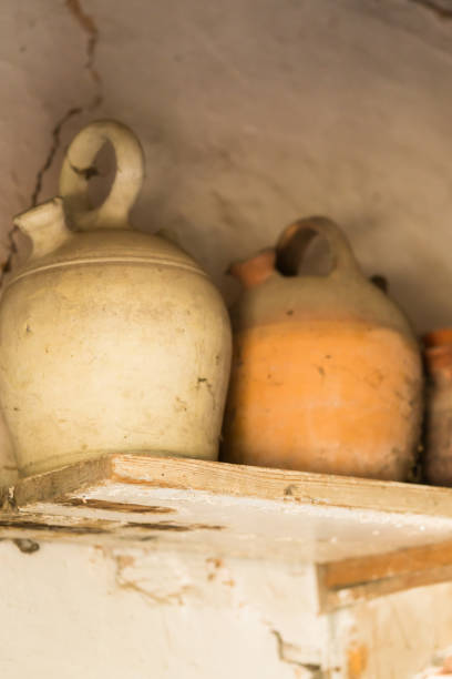 istock Old clay utensil on shabby shelf 858327066