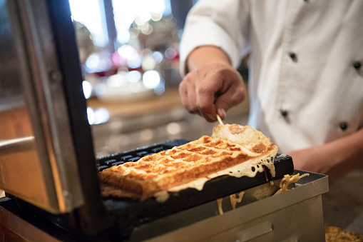 Chef preparing waffles in commercial kitchen