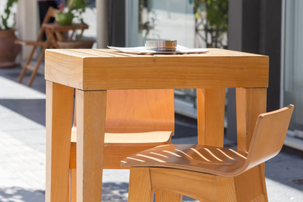 istock wooden coffee table with ashtray and stool on a terrace in a sunny day 858331452