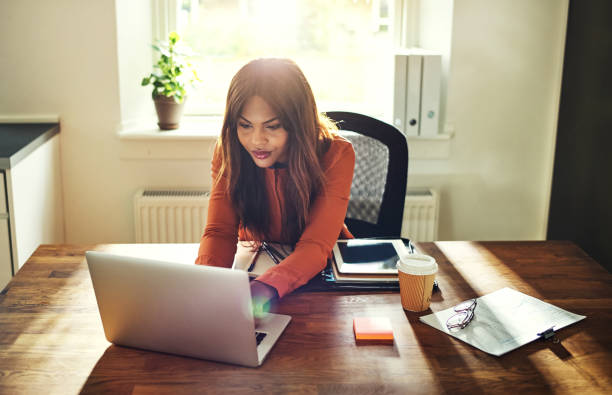 istock Young female entrepreneur working online at a desk at home 858337710