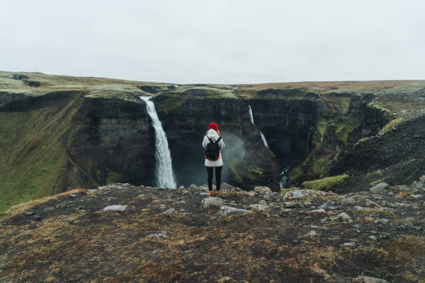 istock Woman looking at  Haifoss    waterfall in mountains 858343992
