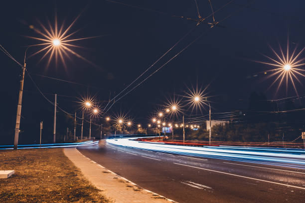 istock Traffic light trails on night urban road 858345078