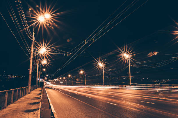 istock Traffic light trails on night urban road 858345288