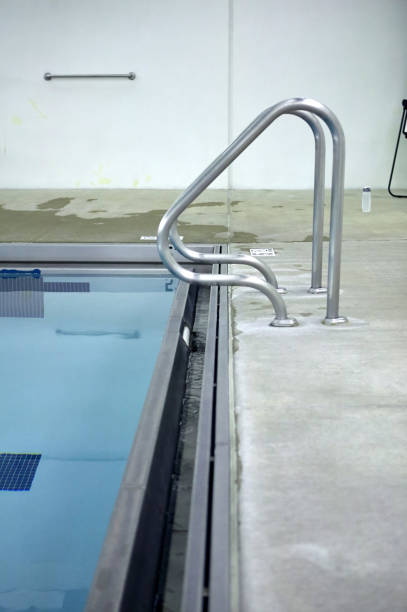 istock Metal handrails on swimming pool steps 858345774