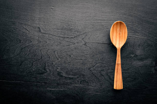 istock Wooden spoon on a black background Wooden. 858348300