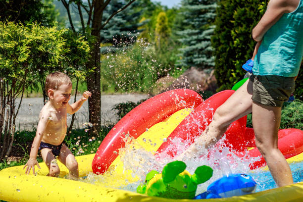 istock Boy Playing in Kids Pool with mother 858349156