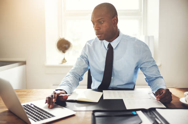 istock Young businessman working on a computer in an office 858350474