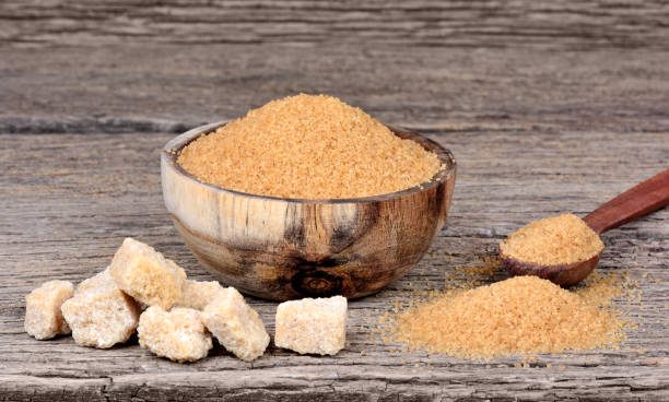 istock Beige sugar in a bowl and spoon on table 858355566
