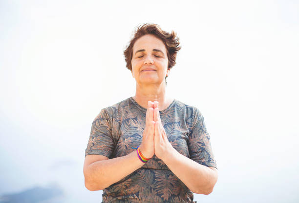 istock Mature woman meditating 858357764