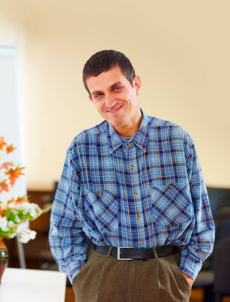 portrait of cheerful adult man with disability in rehabilitation center portrait of cheerful adult man with disability in rehabilitation center developmental disability stock pictures, royalty-free photos & images
