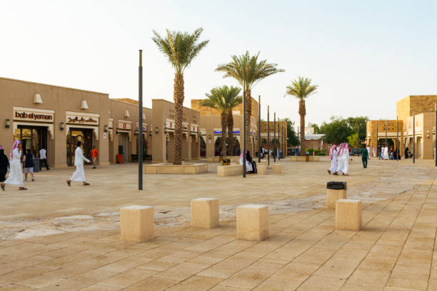 Saudi men and families visiting the outdoor mall in front of the historic Diriyah district, in Riyadh