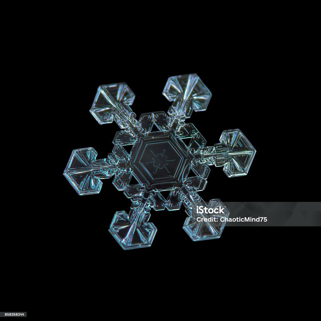 Snowflake isolated on black background Snowflake isolated on black background. Macro photo of real snow crystal: large star plate with six short, simple arms, fine hexagonal symmetry and unusual pattern inside central hexagon. Macrophotography Stock Photo