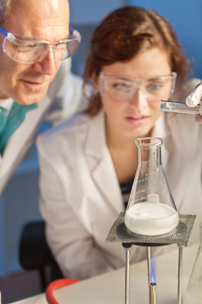 istock Two Scientists Chemist Working Together in a Laboratory in a Chemical Solution 858370404