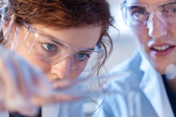 istock Two Scientists Chemist Working Together in a Laboratory in a Chemical Solution 858370418