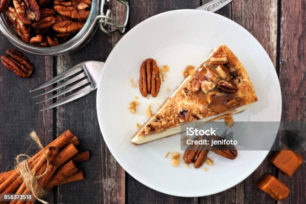 Slice Of Pecan Caramel Cheesecake Top View Over Wood Stock Photo - Download Image Now