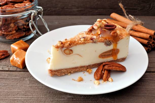 istock Pecan caramel cheesecake with a wood background 858373528