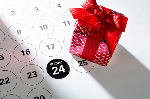 A calendar page with red gift box for the 2017, 2023 Black Friday retail shopping day, marking November 24 Friday, the day after Thanksgiving for the beginning of the Christmas shopping period.