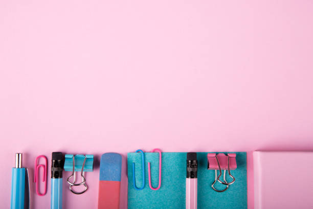 istock Blue and pink office. A lot of school objects on a pink background. 858374524