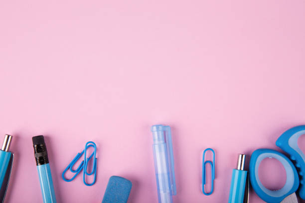 istock Blue and pink office. A lot of school objects on a pink background. 858374760