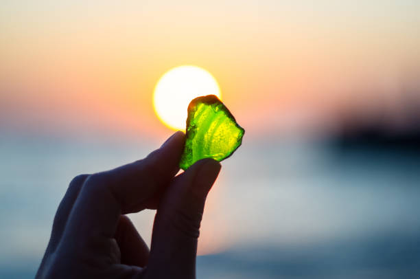 istock sea smoothed green glass in hand 858375024