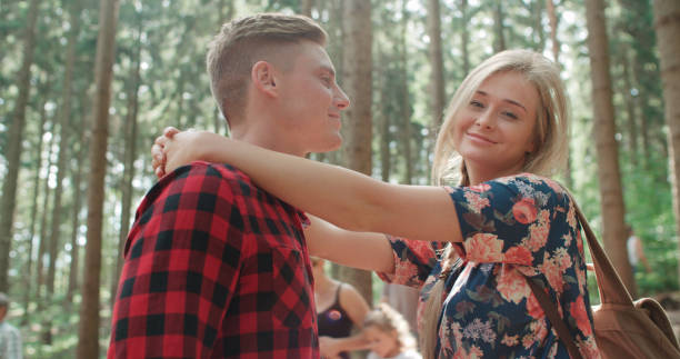 istock Smiling couple hugging each other in woods. 858378076