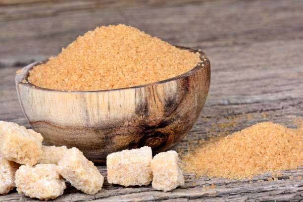 istock Beige sugar in a bowl on wooden table 858381064