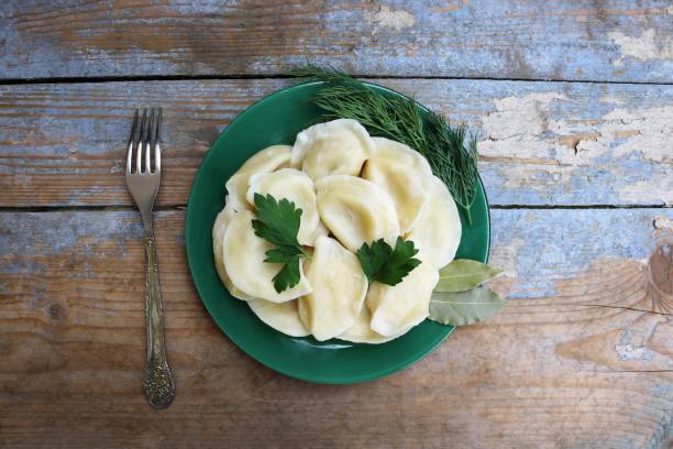 istock Boiled dumplings on a plate. Wooden rustic background. Top view. Copy space. 858382488